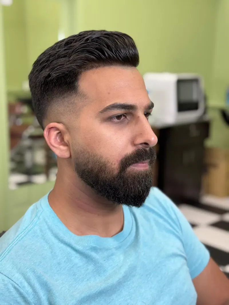 Man with a skin fade, styled top and trimmed beard after a haircut at Dandies Sunnyvale