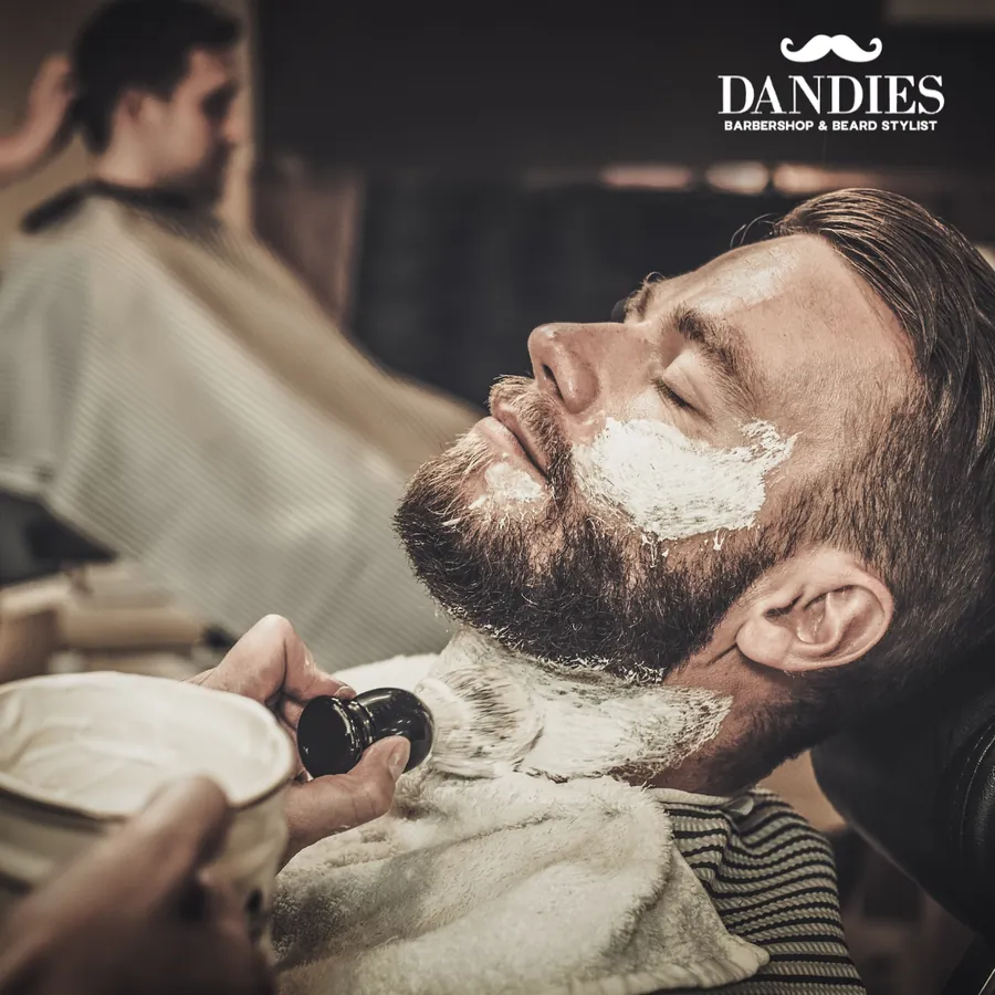 Man leaning back in the chair for a hot lather straight razor shave